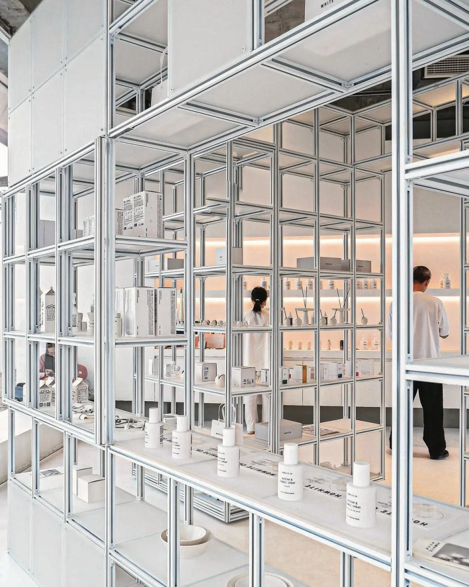 Fragrance products arranged in an aluminum-frame retail display